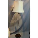 A mid 20th Century mahogany standard lamp with shade.