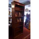 A 20th Century oak bookcase with adjustable shelves, having reeded column supports.