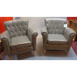 A pair of contemporary grey leather button back arm chairs,