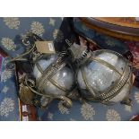 A pair of wall hanging gilt metal storm lanterns