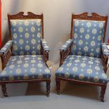 A pair of Edwardian mahogany arm chairs with blue damask upholstery,