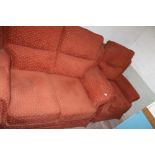 A RED UPHOLSTERED TWO PIECE SUITE