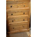 A PINE COLONIAL STYLE FOUR DRAWER CHEST OF DRAWERS