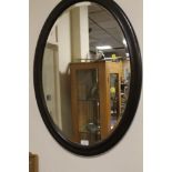 A LARGE OVAL MIRROR TOGETHER WITH ASSORTED MIRRORS