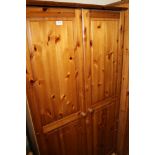 A HONEY PINE DOUBLE WARDROBE