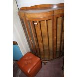 A CHINA DISPLAY CABINET TOGETHER WITH A PINK POUFFE