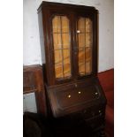 AN OAK LEADED GLASS BUREAU BOOKCASE