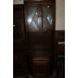 AN OAK LINEN FOLD CABINET