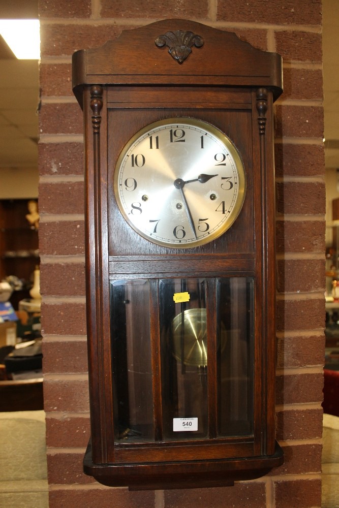 AN EDWARDIAN OAK WALL CLOCK