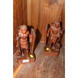 A PAIR OF CARVED TREEN BOOKENDS