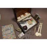 AN OAK BOX OF COLLECTABLES TO INCLUDE STAMPS, TABLE LIGHTER, BADGES ETC