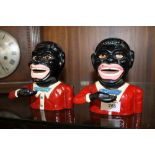 A PAIR OF REPRODUCTION JOLLY JOE MONEY BANKS