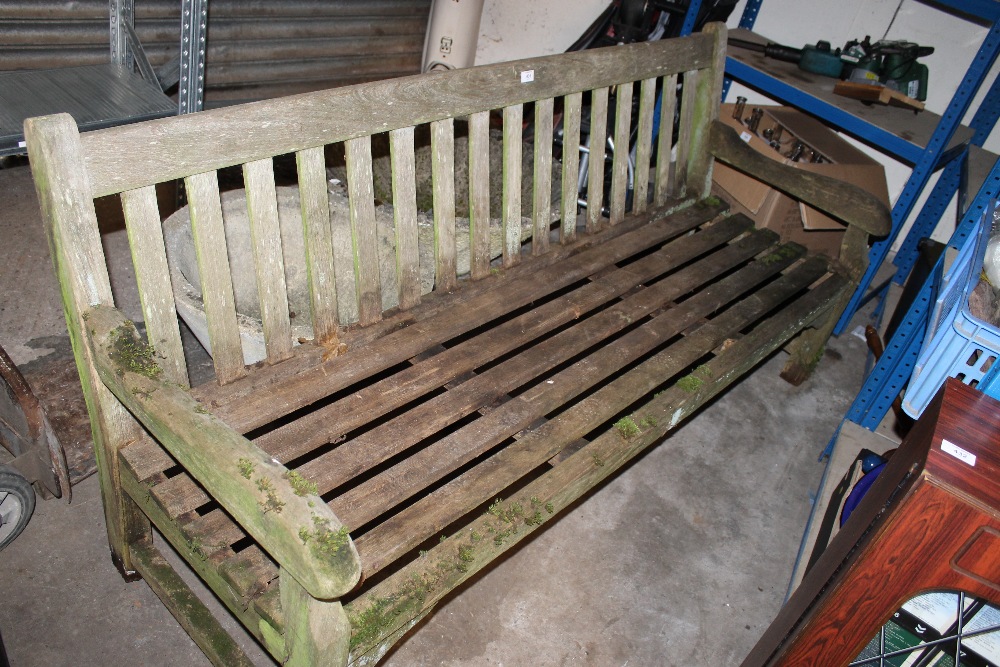 A LARGE WOODEN GARDEN BENCH