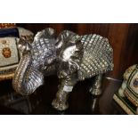 A SILVER MIRRORED FIBREGLASS ELEPHANT FIGURE A/F