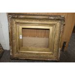 A GILT WOOD ANTIQUE PICTURE FRAME, with slip landscape, 51 x 58 cm