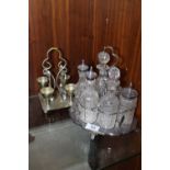 A SILVER PLATED SIX BOTTLE CRUET SET PLUS AN EGG & SPOON SET