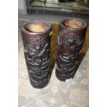 A PAIR OF CARVED ORIENTAL TREEN BRUSH POTS