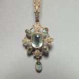 AN EDWARDIAN STYLE AQUAMARINE AND DIAMOND SET PENDANT, suspended on a 9ct gold chain