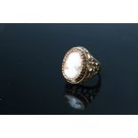 A HALLMARKED 9 CARAT GOLD CAMEO RING, set in a raised pierce gallery, approx weight 5.8 g, ring siz