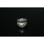 A WHITE GOLD DRESS RING, stamped 750, set with white and black stones, ring size J