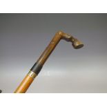 A 19TH CENTURY WALKING STICK WITH CARVED HORN HANDLE, in the form of a horse hoof, metal ferrule, o