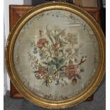 AN 18TH CENTURY OVAL NEEDLEWORK FLORAL SAMPLER, framed and glazed, 39 x 35 cm