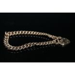 A HALLMARKED 9 CARAT GOLD GRADUATED CURB LINK GATE BRACELET, approx weight 32 g