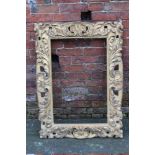 A 19TH CENTURY GILTWOOD FLORENTINE STYLE PICTURE FRAME, of rectangular outline, rebate 78 x 49 cm