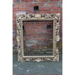 A LATE 18/EARLY 19TH CENTURY GILTWOOD FLORENTINE STYLE PICTURE FRAME, of rectangular outline, rebat