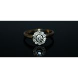 AN 18 CARAT GOLD ELEVEN STONE OLD CUT DIAMOND RING, the central diamond being of approx 0.14 carat