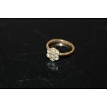 AN 18CT GOLD SEVEN STONE FLORAL SET DIAMOND RING