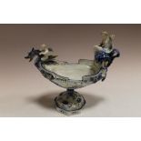 A CONTINENTAL CERAMIC NAUTILUS URN WITH CHERUBS A/F