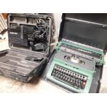 A CASED HITATCHI VHS CAMCORDER + A CASED SILVER REED TYPEWRITER