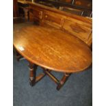 A SMALL OAK TILT TOP TABLE