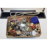 A BOX OF COSTUME JEWELLERY, BADGES ETC