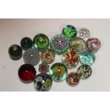 A LARGE COLLECTION OF APPROXIMATELY SEVENTEEN GLASS PAPER WEIGHTS