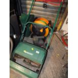 AN ELECTRICAL QUALCAST LAWN MOWER TOGETHER WITH A 12 VOLT BATTERY CHARGER & HOSE REEL