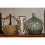 A LARGE GLASS CARBOY, CERAMIC STICK STAND PLUS A LARGE WICKER BASKET