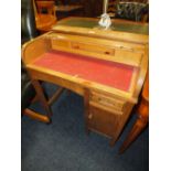 A SMALL CHILDS OAK ROLL TOP DESK