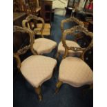 A SET OF FOUR VICTORIAN ROSEWOOD CARVED DINING CHAIRS