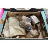A RARE WWII BRITISH GAS MASK, CANVAS COVERED MASK AND TAN COLOURED FILTER, WITH 1941 DATED BAG AND