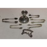 A BAG OF HALLMARKED SILVER TO INCLUDE A CANDLESTICK, SUGAR TONGUES AND A BRACELET