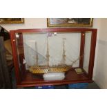 A LARGE GLASS CASED HAND MADE MODEL OF A GALLEON