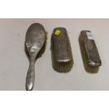A HALLMARKED SILVER HAMMERED FINISH SET OF THREE BRUSHES A/F