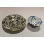 AN ORIENTAL TEA BOWL RAISED ON FOOTED BASE, typical blue and white decoration to the interior,