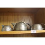 AN ARTS AND CRAFTS STYLE HOMELAND THREE PIECE PEWTER TEA SET