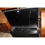 A TOSHIBA FLATSCREEN TV ON STAND