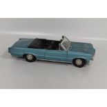 A MODEL OF A PONTIAC "ERTL 1/12 1964 GTO" IN BLUE