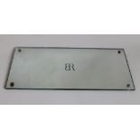 A SMALL PLATE GLASS MIRROR WITH B.R. LOGO 41cm x 20cm