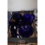 A TRAY OF BLUE GLASS ITEMS TO INCLUDE DECANTERS, JUG ETC.